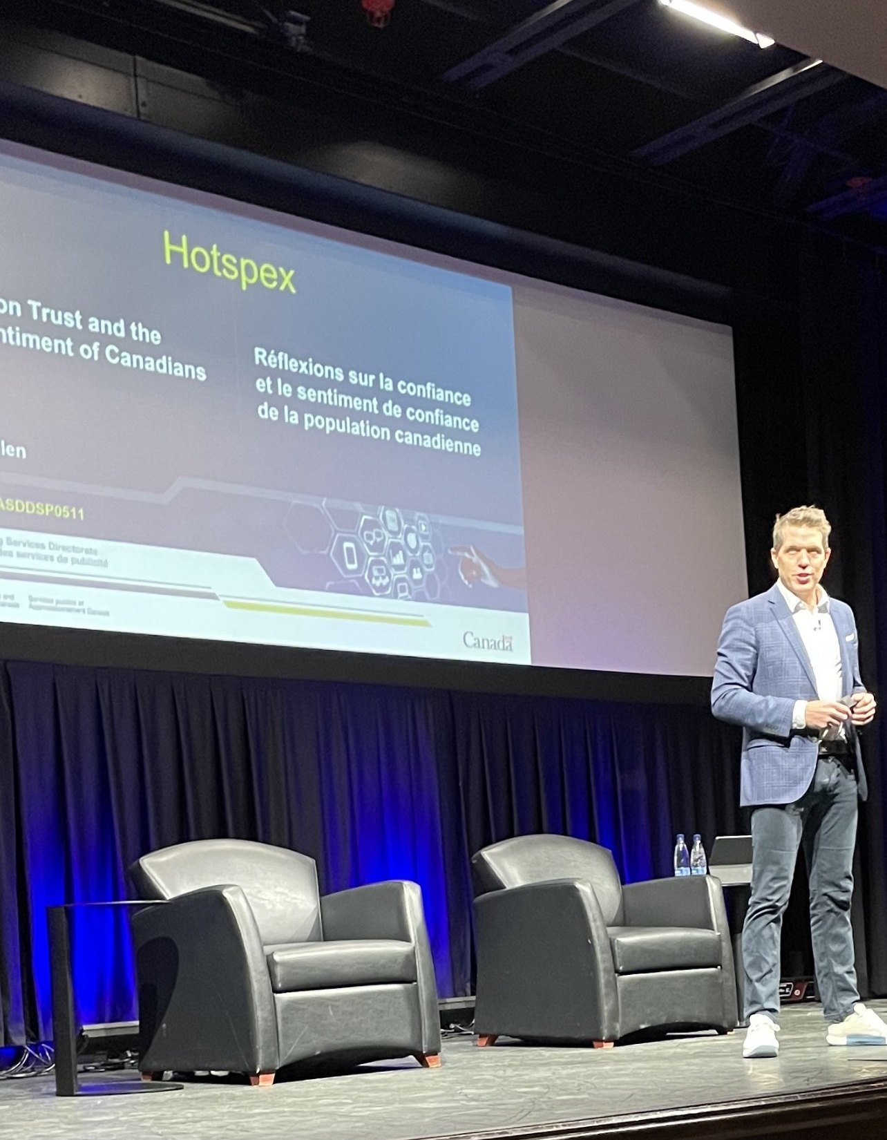 Shane Skillen on stage at a Government of Canada event on trust and the sentiment of Canadians